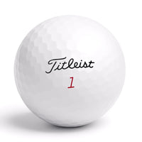 Närbild på Titleist golfboll med logga och röd siffra